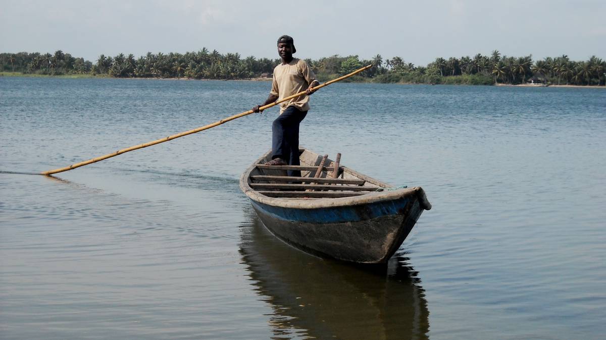 Day Trip to Ada Man in canoe on the Volta River