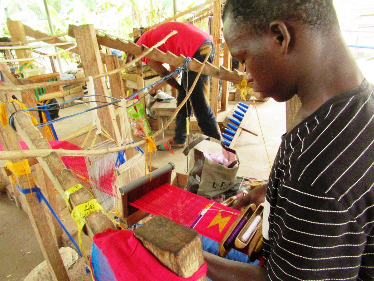 Kente Weaving Workshop Kente weaver at loom in Adanwomase