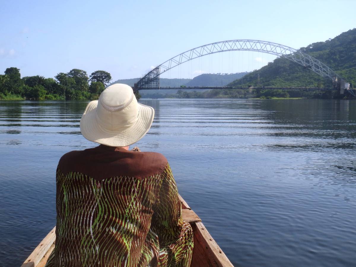 Day Trip to the Volta River Guest in dugout canoe approaching the Adomi Bridge crossing the Volta River