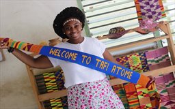 Person with Kente cloth strip