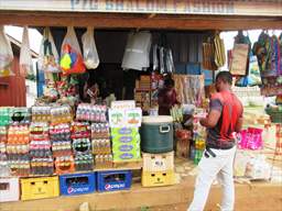 making purchase at roadside market in ghana