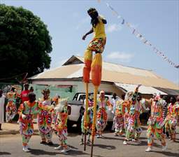 man on stilts at ghana festival