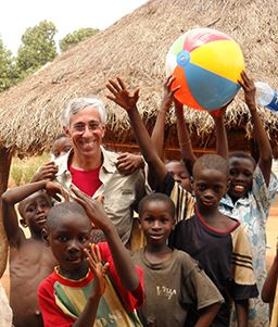 man with children in ghana village