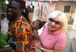 woman assisting ghana man with baby